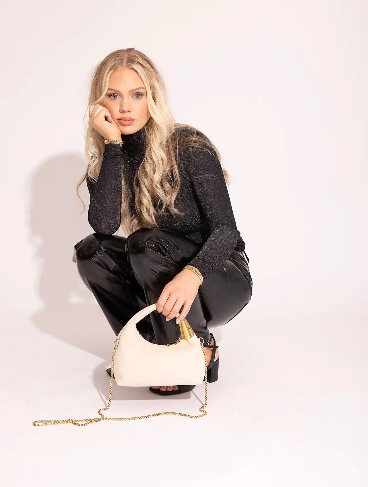 model with a white clutch bag